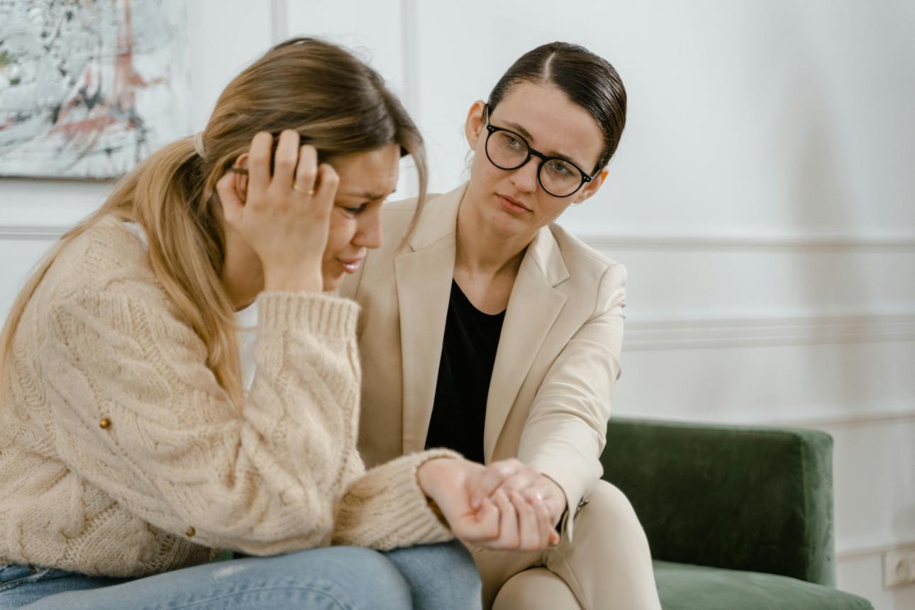 Woman comforting distressed friend