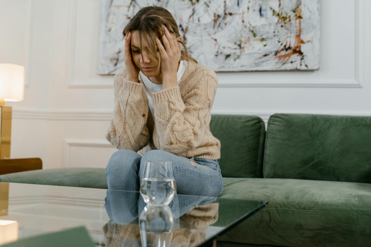 Woman looking distressed on couch